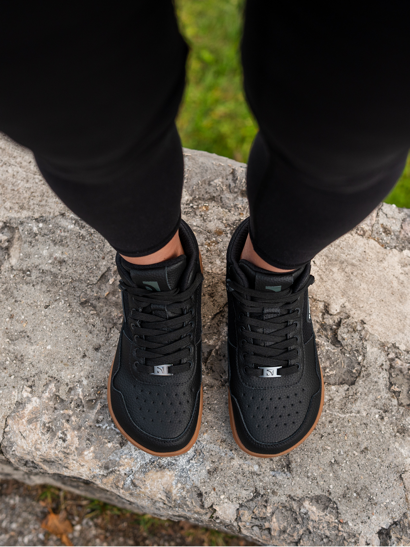 Barefoot zimní nepromokavé kotníkové boty Barebarics UrbanEdge - Black černé s béžovou podrážkou pohled na obuté boty shora stojící na kameni