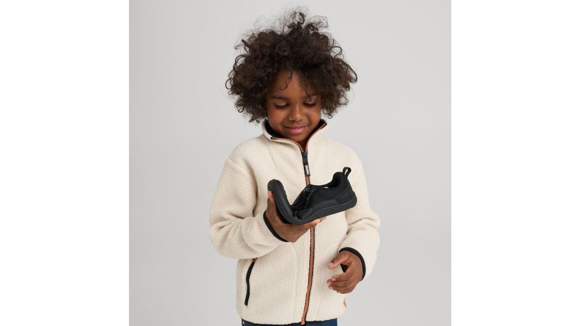 Reima Tallusteli Black - dětské barefoot tenisky s voděodolnou membránou v černé barvě s rychloupínáním - pohled na dítě zkoušející ohebnost boty